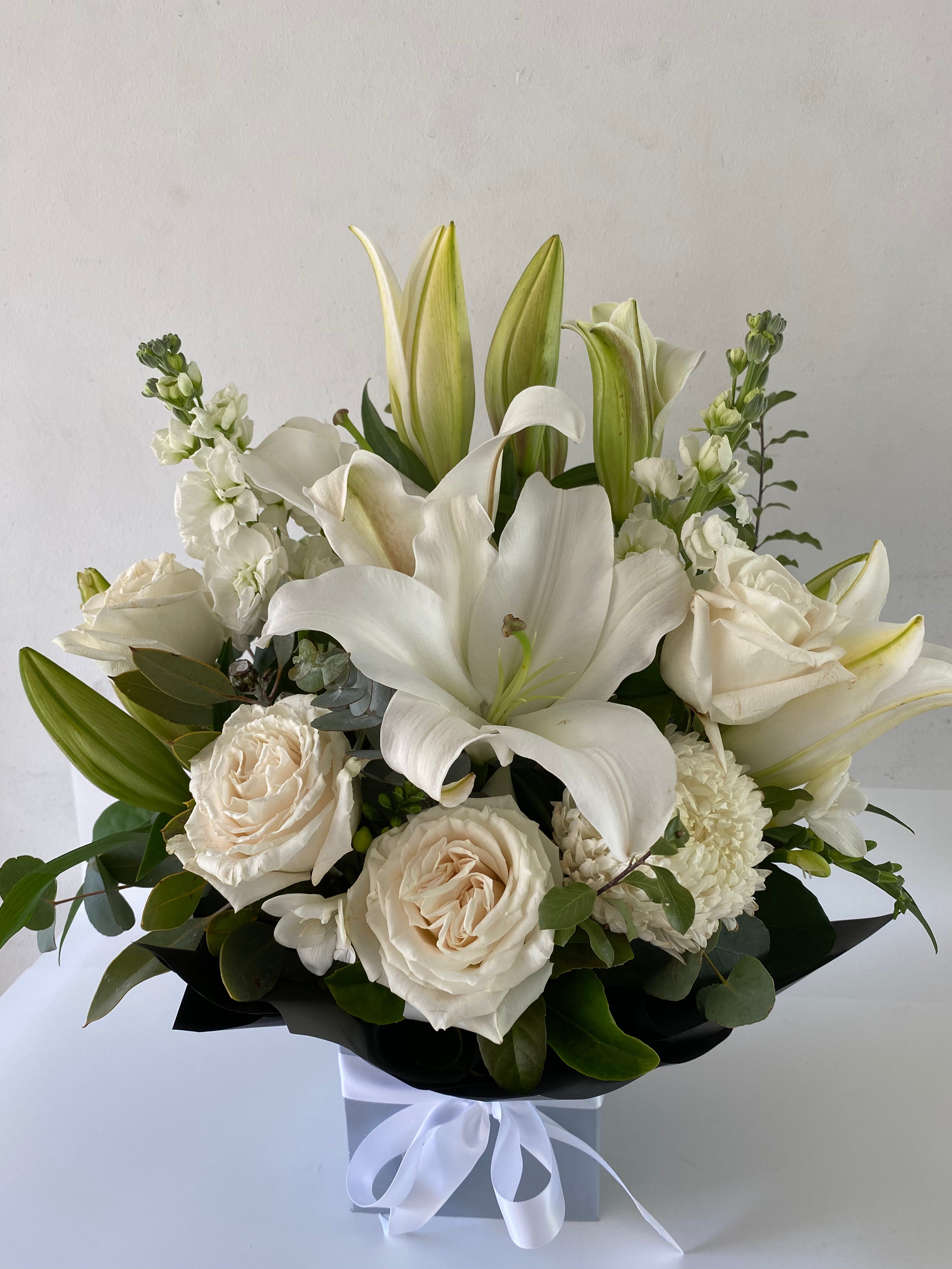 Oriental lillies, disbuds, roses and other seasonal white flowers